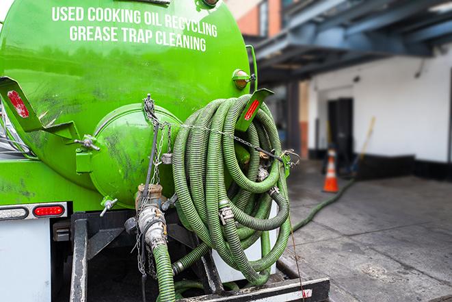 grease trap being pumped out by service technician in Blue Springs